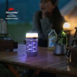 Naturehike NH22ZM005 mosquito killer lamp standing on a camp table in mosquito mode