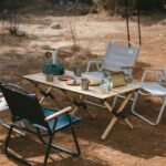 Naturehike Star Jane L01 egg roll table laid out with camp chairs and a stove