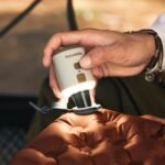 Naturehike Wind Mini air pump with the lamp shade fitted, held in hand