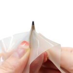 Clear TPU repair tape being pressed onto a surface