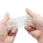 Backing being peeled from a piece of clear TPU repair tape