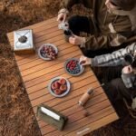 Overhead view of the wood-grain aluminium slat top of the Naturehike CNH22JU038 folding table